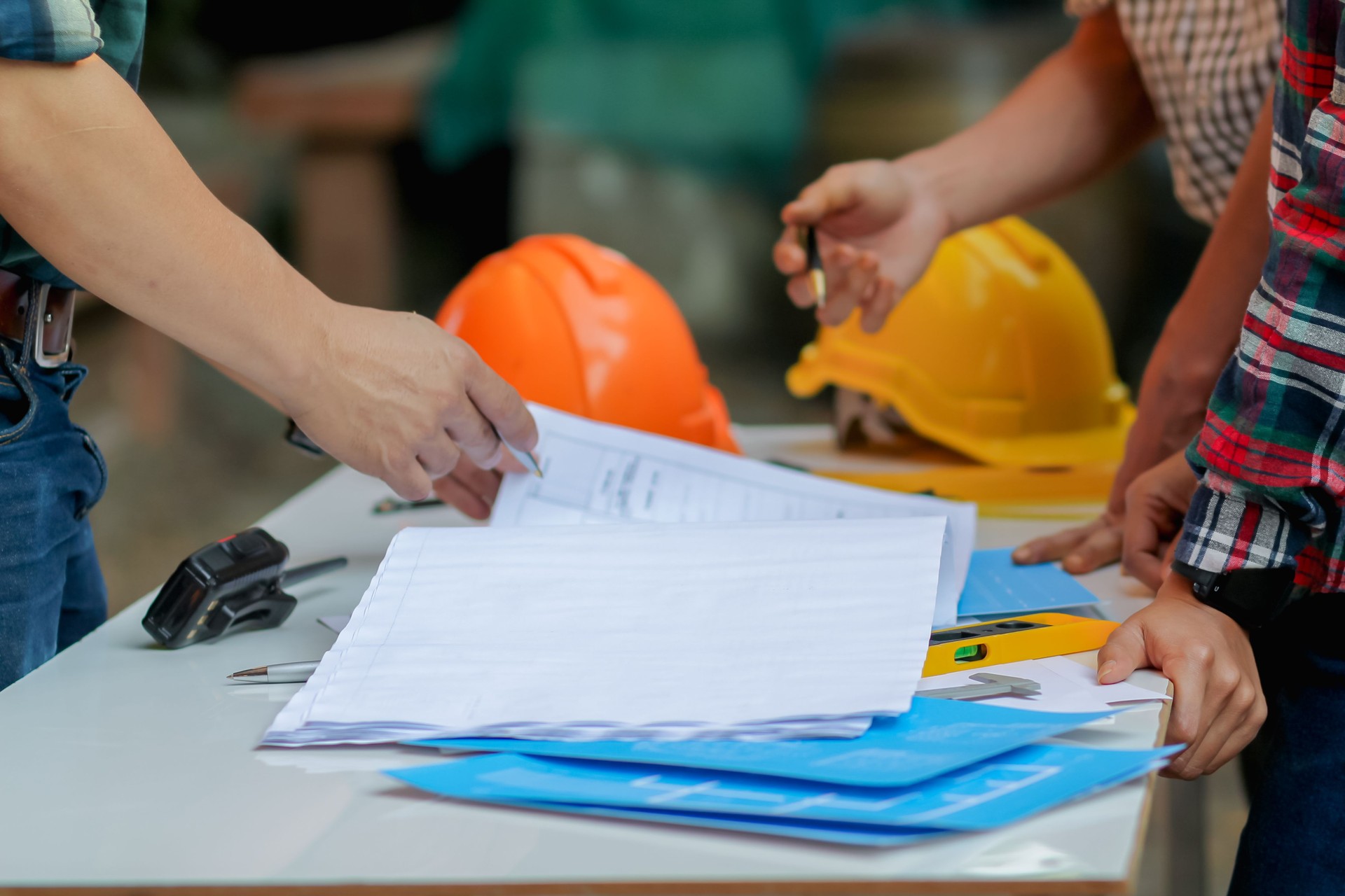 Blurred image, engineer is giving advice and consulting with the designer to find out construction site where engineer will have to construct the project. Consultation between engineers and designers